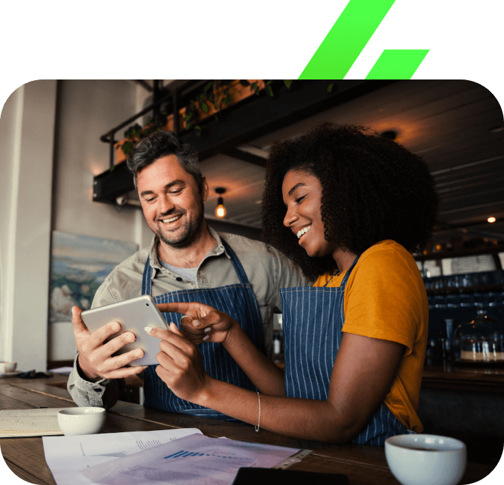 two-coffee-shop-employees-using-a-tablet